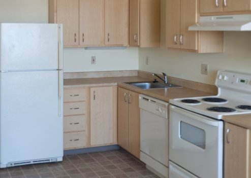 An empty apartment kitchen.