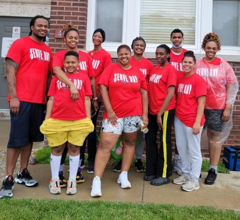 A group of volunteers in red serve day t-shirts