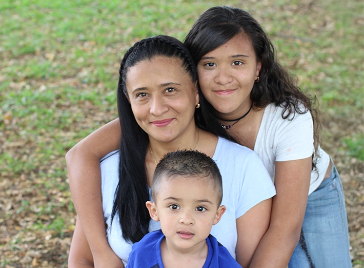 A smiling family outdoors.