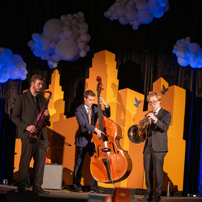 A trio playing music at The Rent Party.