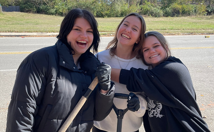 Three volunteers working with Community Linc.