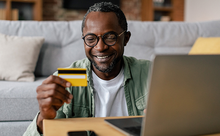 A smiling man signing up for monthly giving.