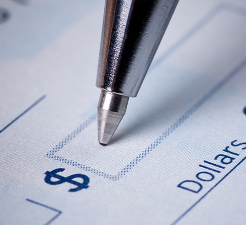 A ballpoint pen about to write in a dollar amount